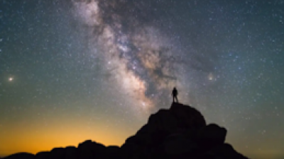 Man on rock cosmos