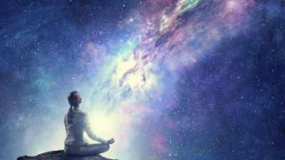 Woman meditating galaxy